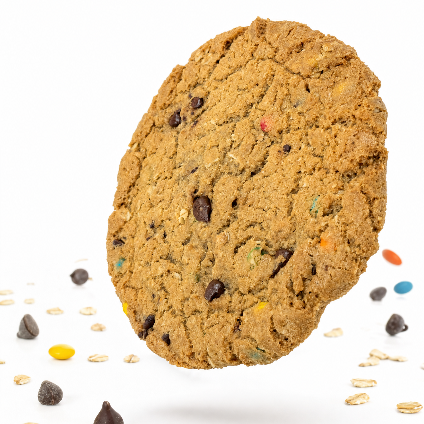 Cookie with chocolate chips and colorful candies on a white background