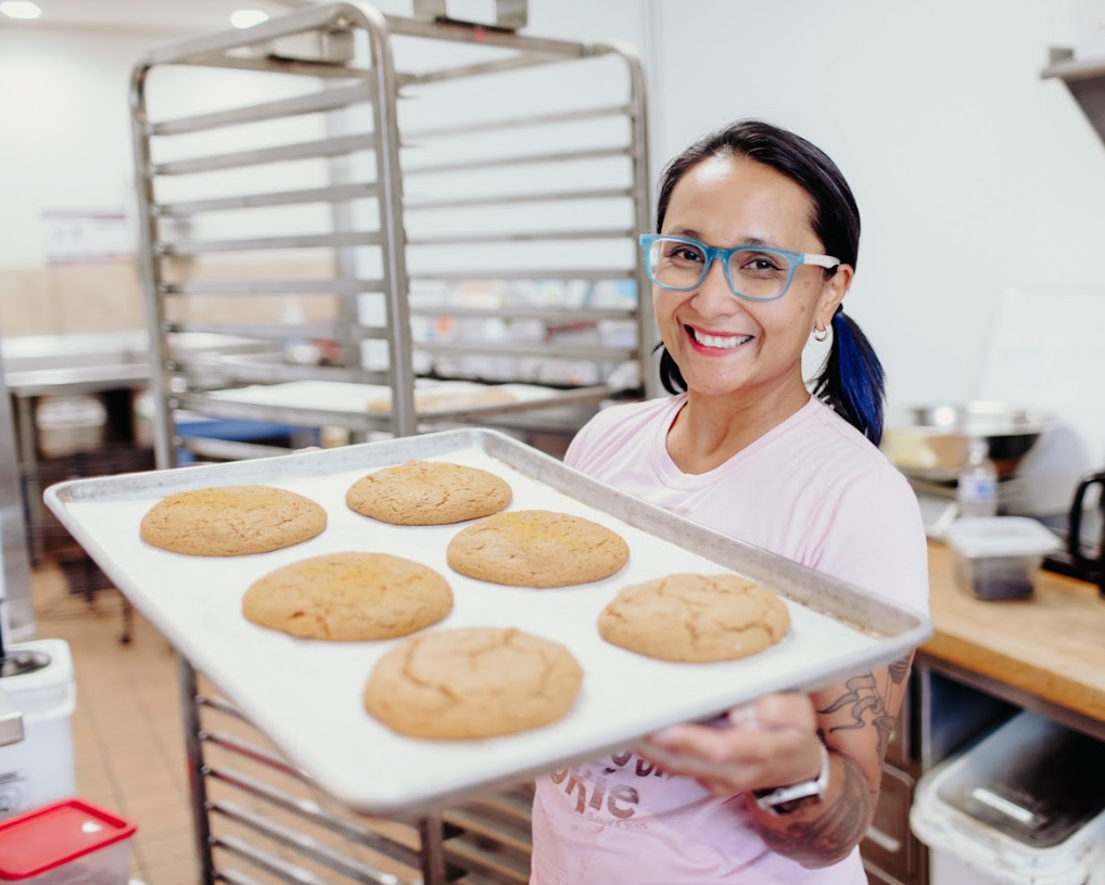 Woman holding tray of cookies