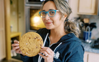 tina from T-Rex Cookie with a cookie